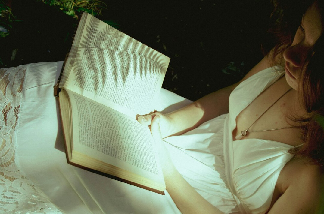 person reading book at night