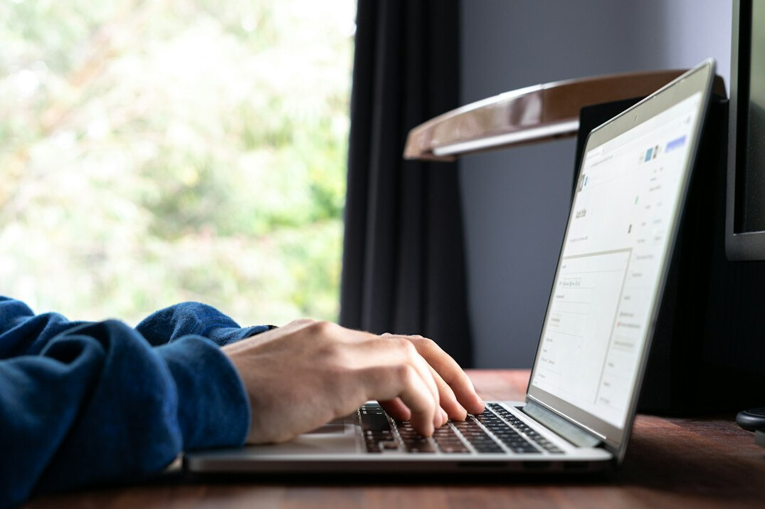writer typing on laptop at night